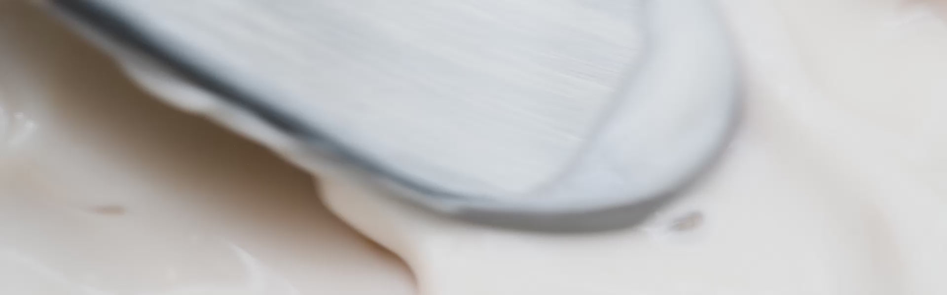 Focus on the texture of La Crème with a slight artistic blur, spatula mixing